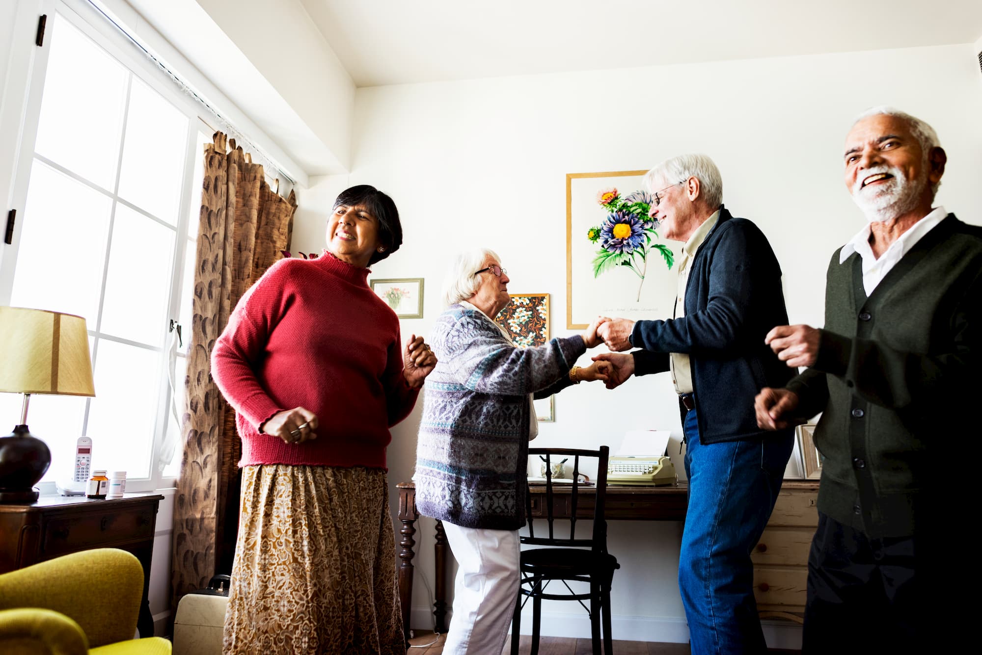 senior friends dancing at home